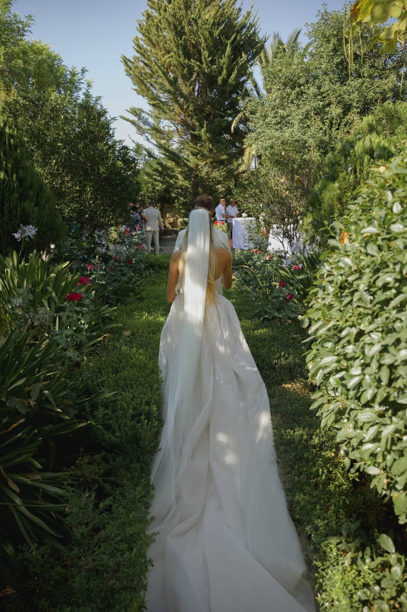 A bride walking through the estate garden
