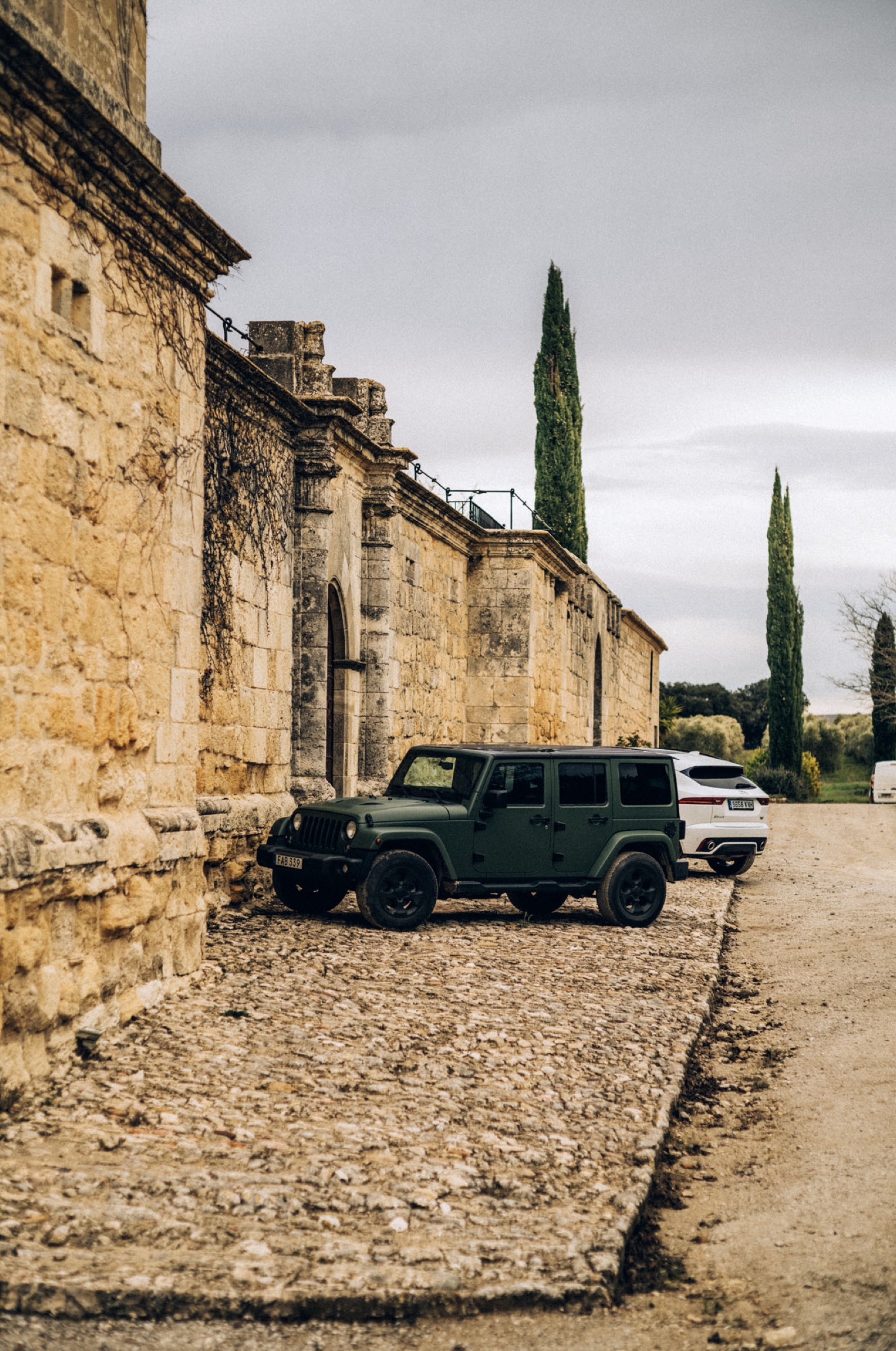 Cars by the stone gate