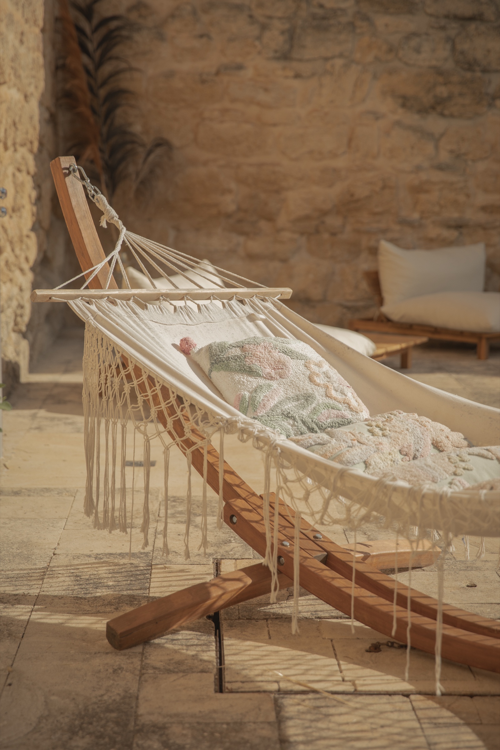 A hammock in a stone courtyard